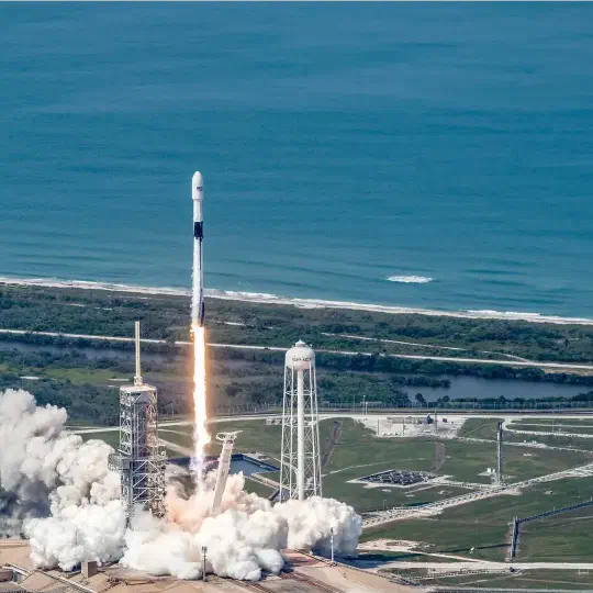 A rocket rising from a launch platform